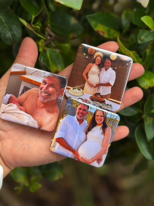 Photo button magnets personalized with family pictures held in a hand